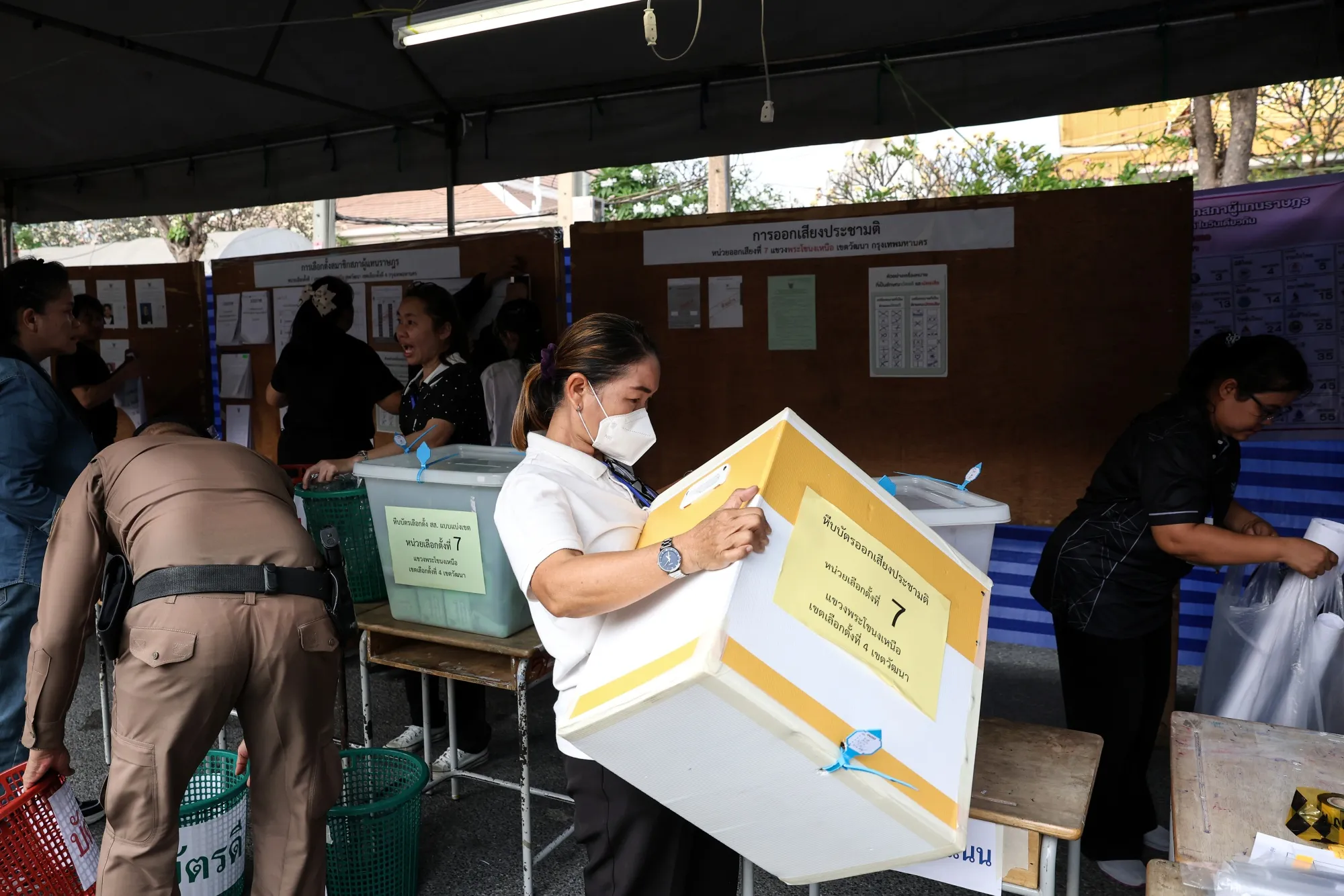 Electoral officials prepare to open ballot boxes at a polling station during Thailand’s general election in Bangkok, Thailand, on Feb. 8.