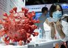 An employee displays a coronavirus vaccine candidate from China National Biotec Group (CNBG) during the 2020 China International Fair for Trade in Services (CIFTIS) in Beijing, China, on Sept. 5