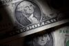 U.S. dollar bills are arranged for a photograph in New York, U.S., on Tuesday, July 26, 2011.The dollar slid to a record low versus the Swiss franc, stocks fell and the cost of insuring U.S. debt rose to a 17-month high as Democrats and Republicans continued to wrangle over competing plans to cut the deficit.