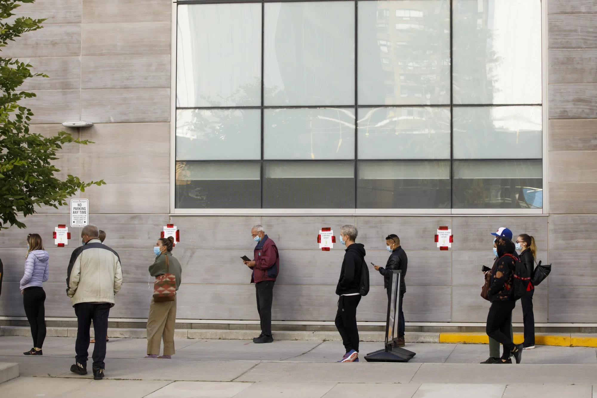 People wait in line outside a Covid-19 testing center in Toronto last month.