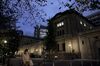 A pedestrian wearing a protective face mask walks past the Bank of Japan (BOJ) headquarters at dusk in Tokyo, Japan, on Monday, Sept. 14, 2020. The Bank of Japan left its bond-purchase amount unchanged at a regular operation on Monday.