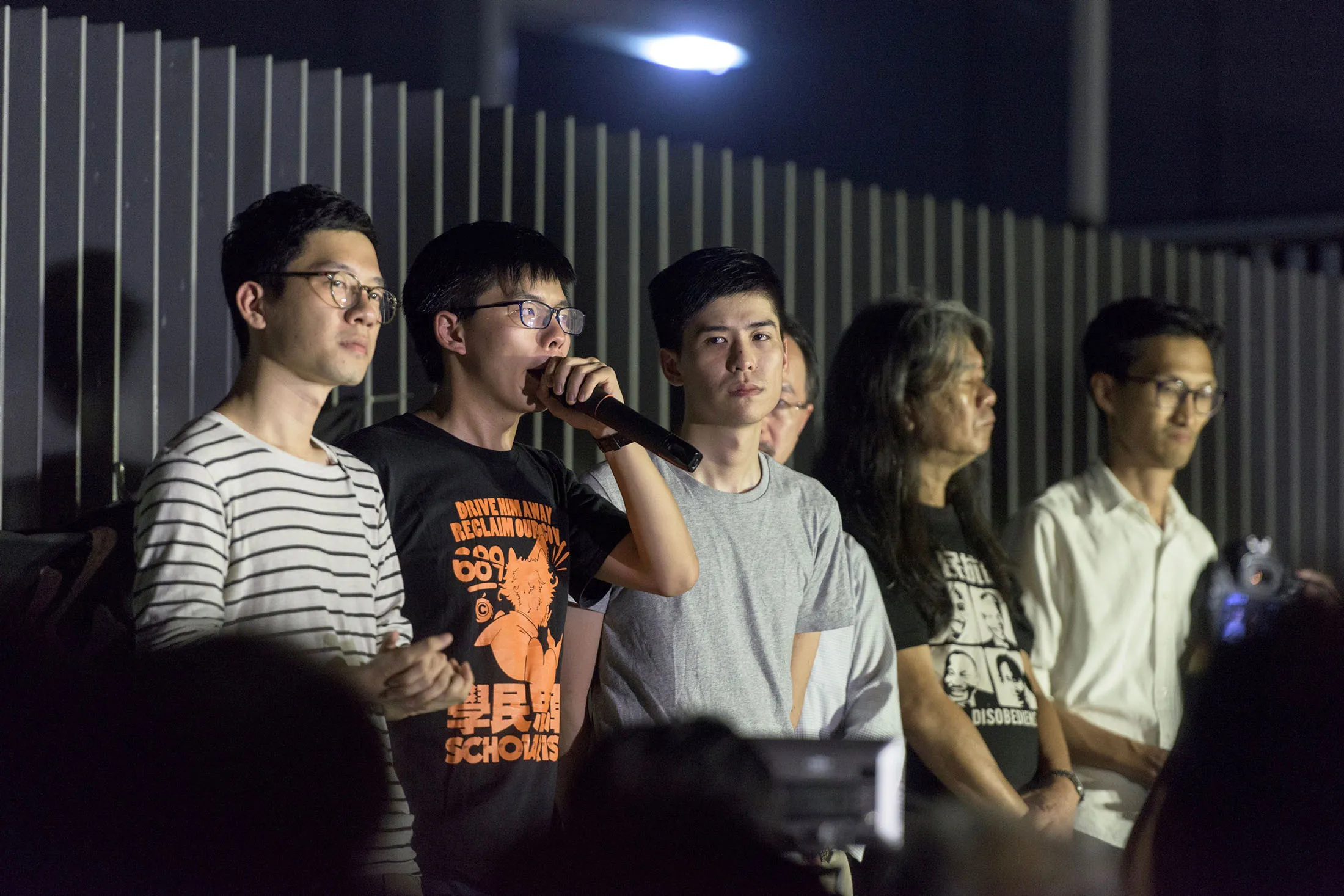 Joshua Wong, second from left, speaks next to fellow pro-democracy activists outside the government headquarters in Hong Kong on Aug. 16.
