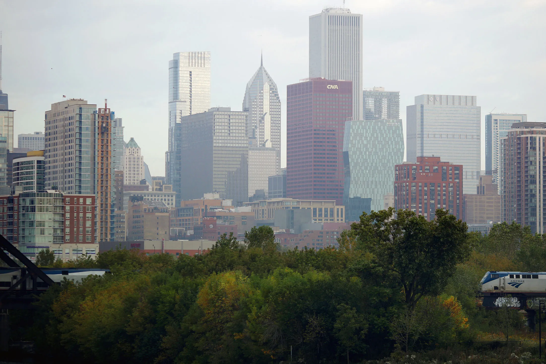 An Amtrak passenger train travels past the skyline of Chicago, Illinois, on Oct. 7, 2015.
