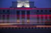 The Marriner S. Eccles Federal Reserve building stands past passing vehicles in Washington, D.C., U.S.