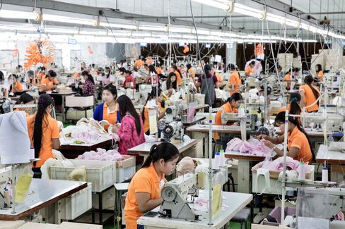 Workers toil over sewing machines at a Saha Pathana factory in Mae Sot.