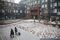 Two people carry their luggage across the courtyard at You+ in Beijing