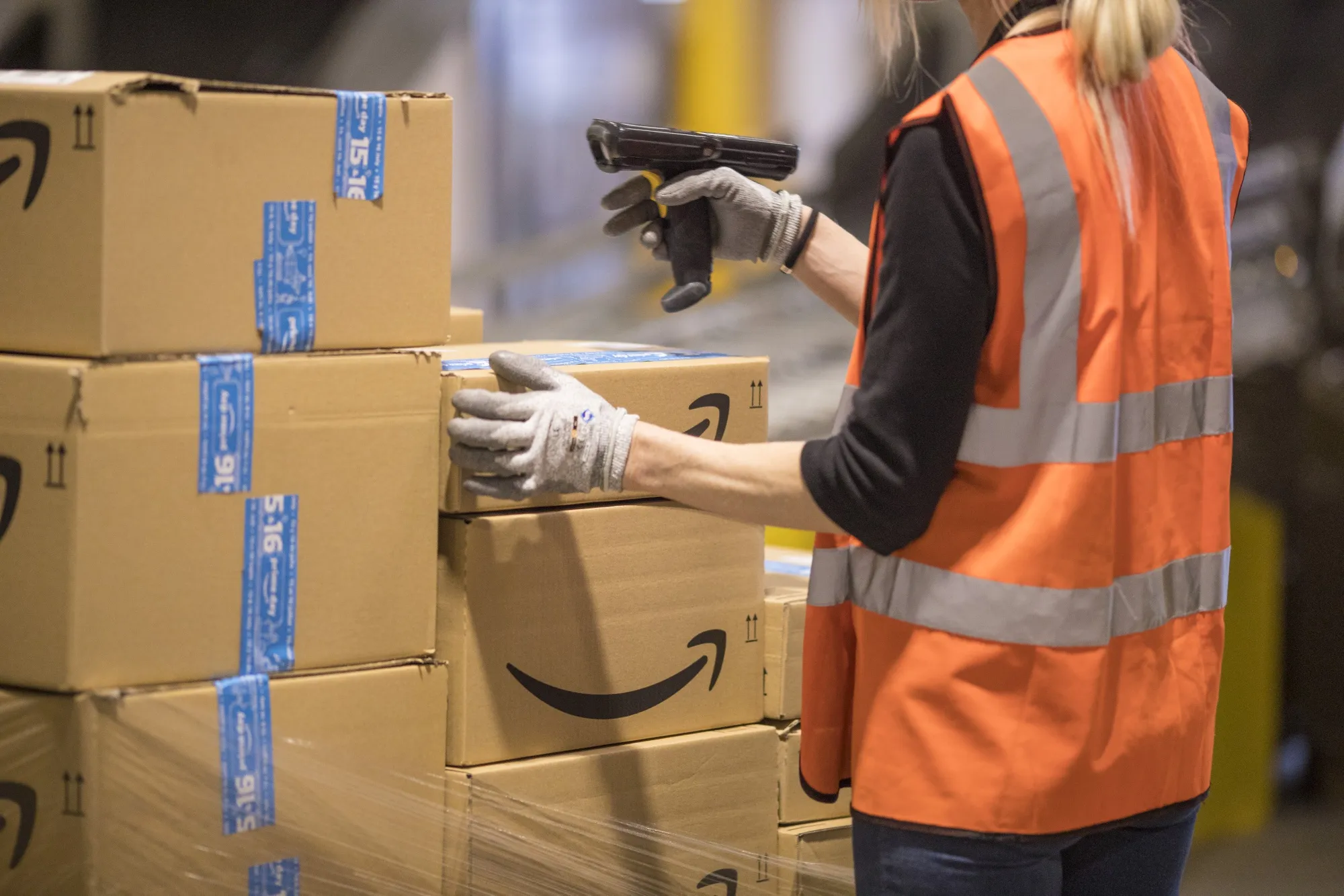 An employee checks packages at an Amazon.com Inc. fulfilment center.