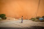 A resident walks in front of a sandstorm in Dollow, southwest Somalia, on March 14.