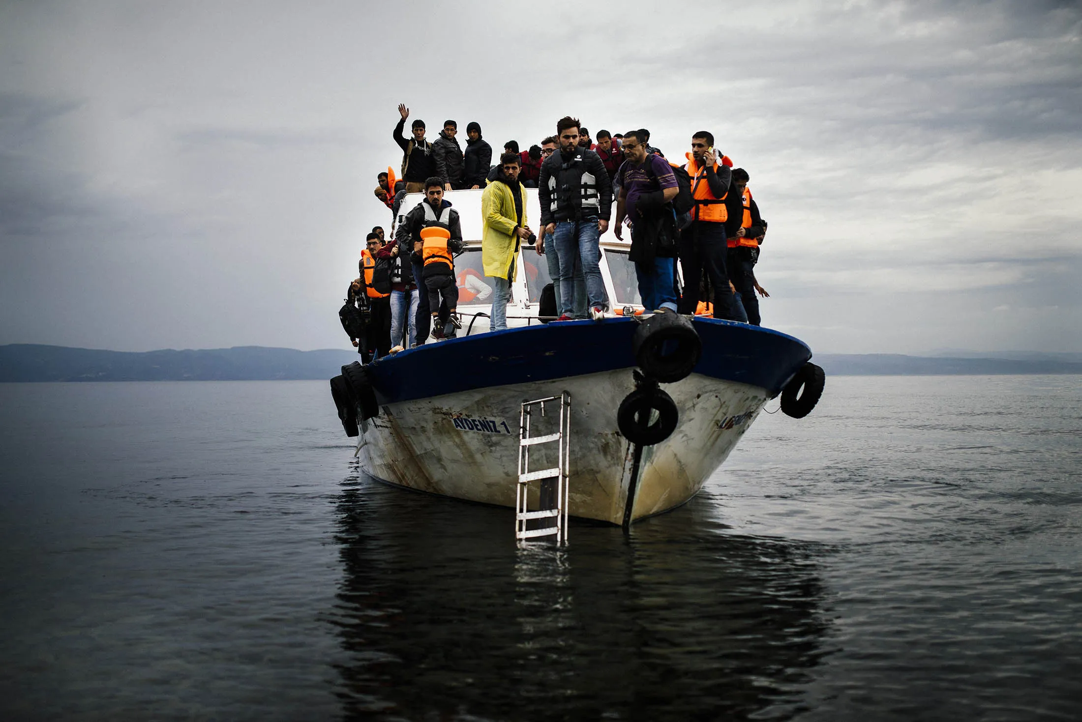 Refugees and migrants arrive by boat on the Greek island of Lesbos after crossing the Aegean sea from Turkey on Oct. 11.
