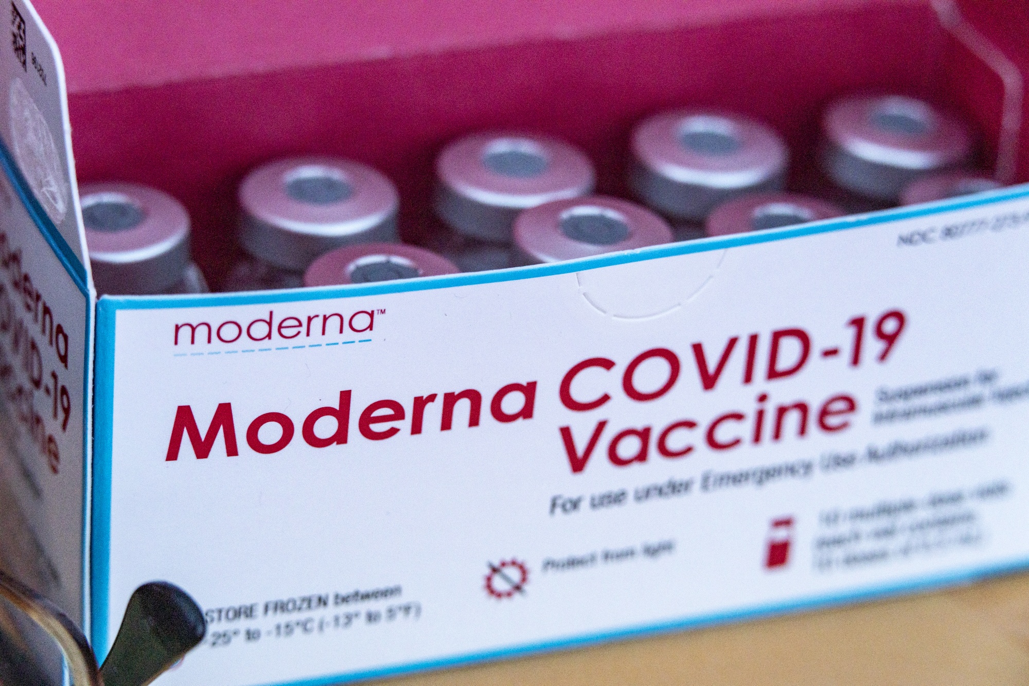 A box of the Moderna Covid-19 vaccine vials at a drive-thru vaccination site at the Meigs County fairgrounds in Pomeroy, Ohio, U.S., on Thursday, March 18, 2021. President Joe Biden is poised to meet his goal of delivering 100 million Covid-19 vaccine shots in his first 100 days in office as soon as Thursday, reaching the milestone more than a month ahead of time.
