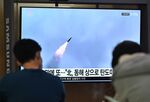 People watch a television screen showing a news broadcast with footage of a North Korean missile test&nbsp;in Seoul.