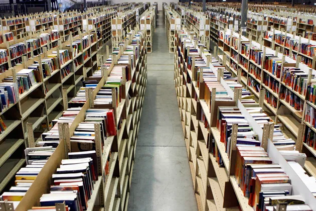 Textbooks sit on shelves at the Chegg warehouse in Shepherdsville, Ky.