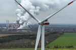 The Niederaussem lignite fueled power station, beyond a wind turbine in Bergheim Niederaussem, Germany.