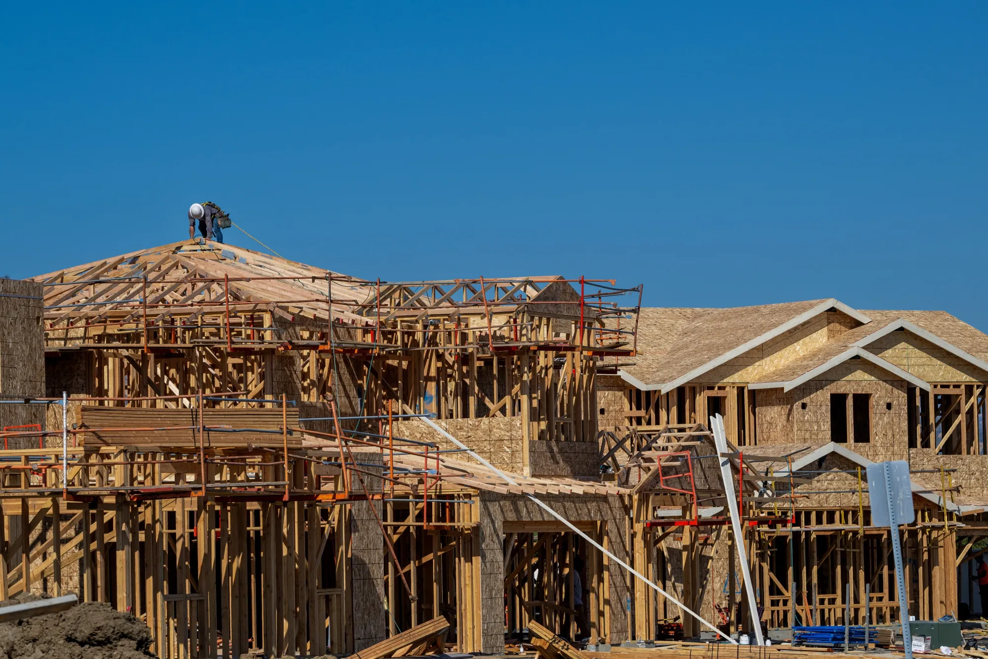 A worker on the roof of a new home under construction in Vacaville, California.