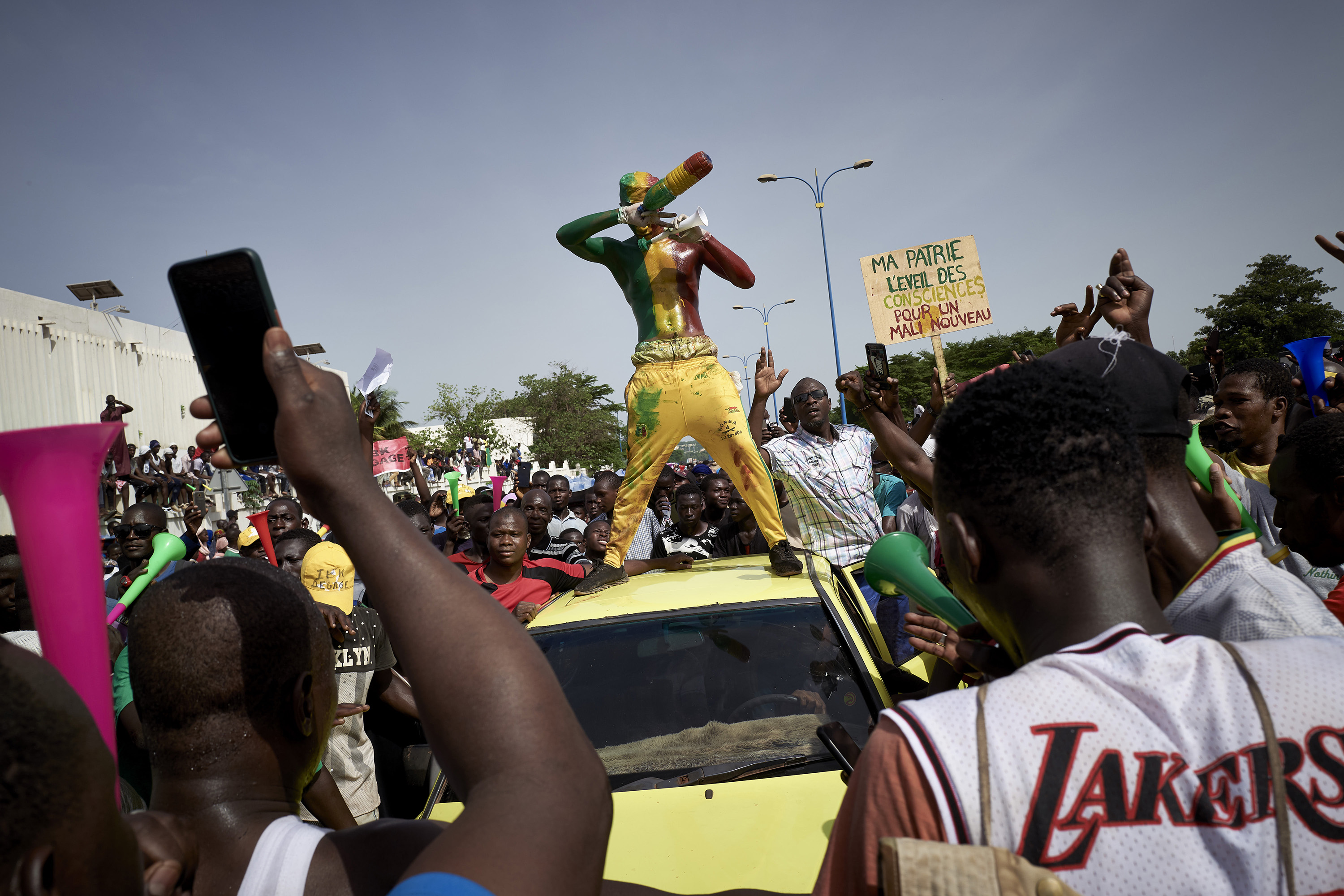 A man painted in the colours of Malian flag gestures at Independance square as protesters gather to demand the resignation of Ibrahim Boubacar Keita, in Bamako on June 19.