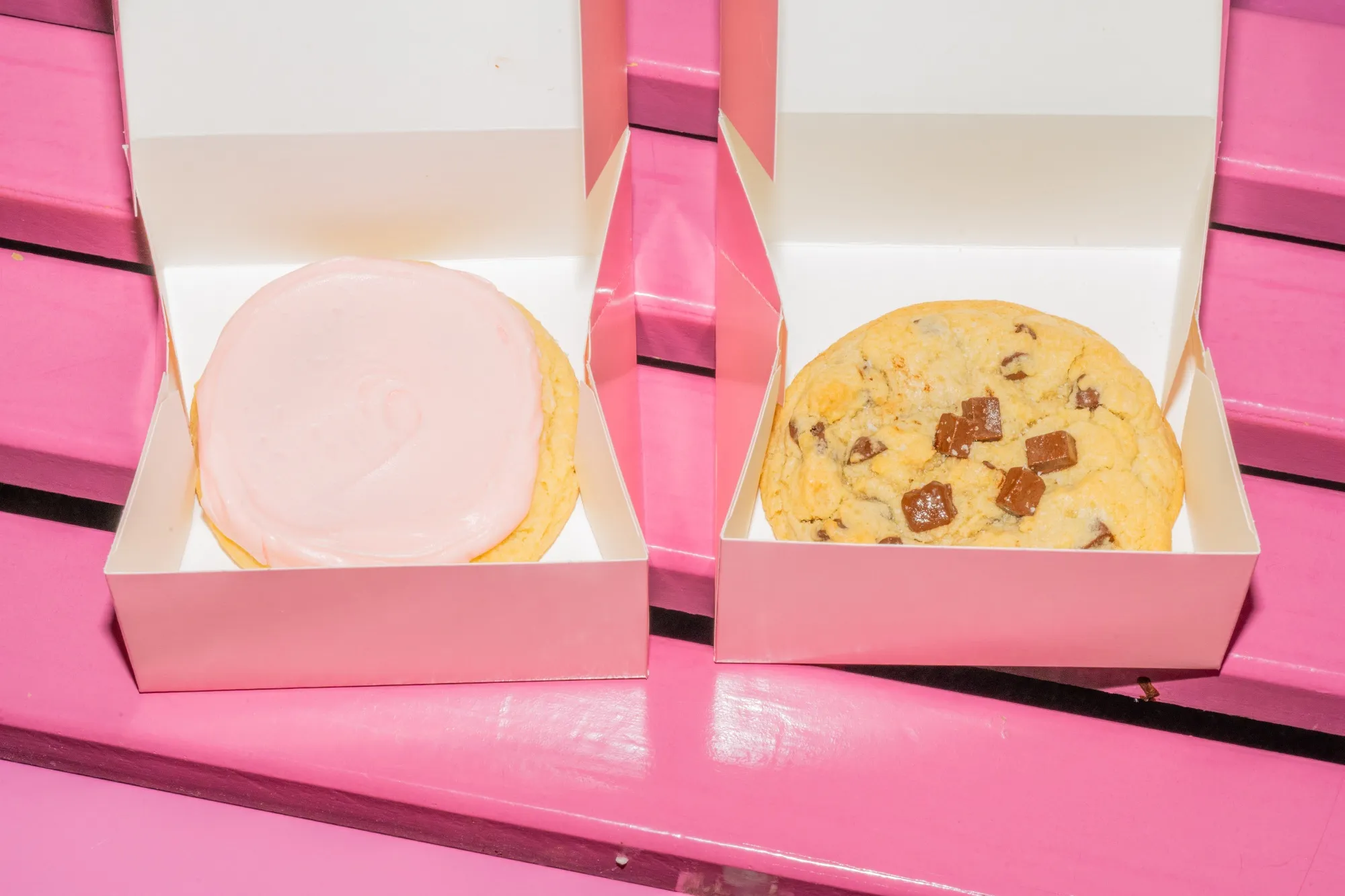 Crumbl’s&nbsp;pink sugar and milk chocolate chip cookie in the company’s signature pink box.