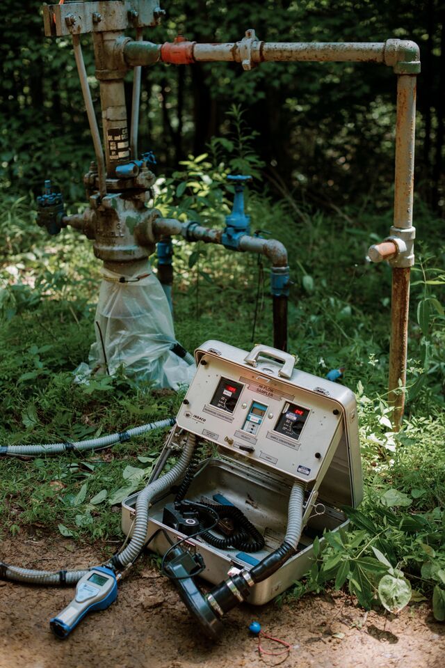 Amy Townsend-Small (right), an associate professor of environmental science at the University of Cincinnati, is one of a growing tribe of methane hunters. She uses an Indaco Hi-Flow Sampler (left) to measure methane escaping from a leaking natural gas well in West Virginia.