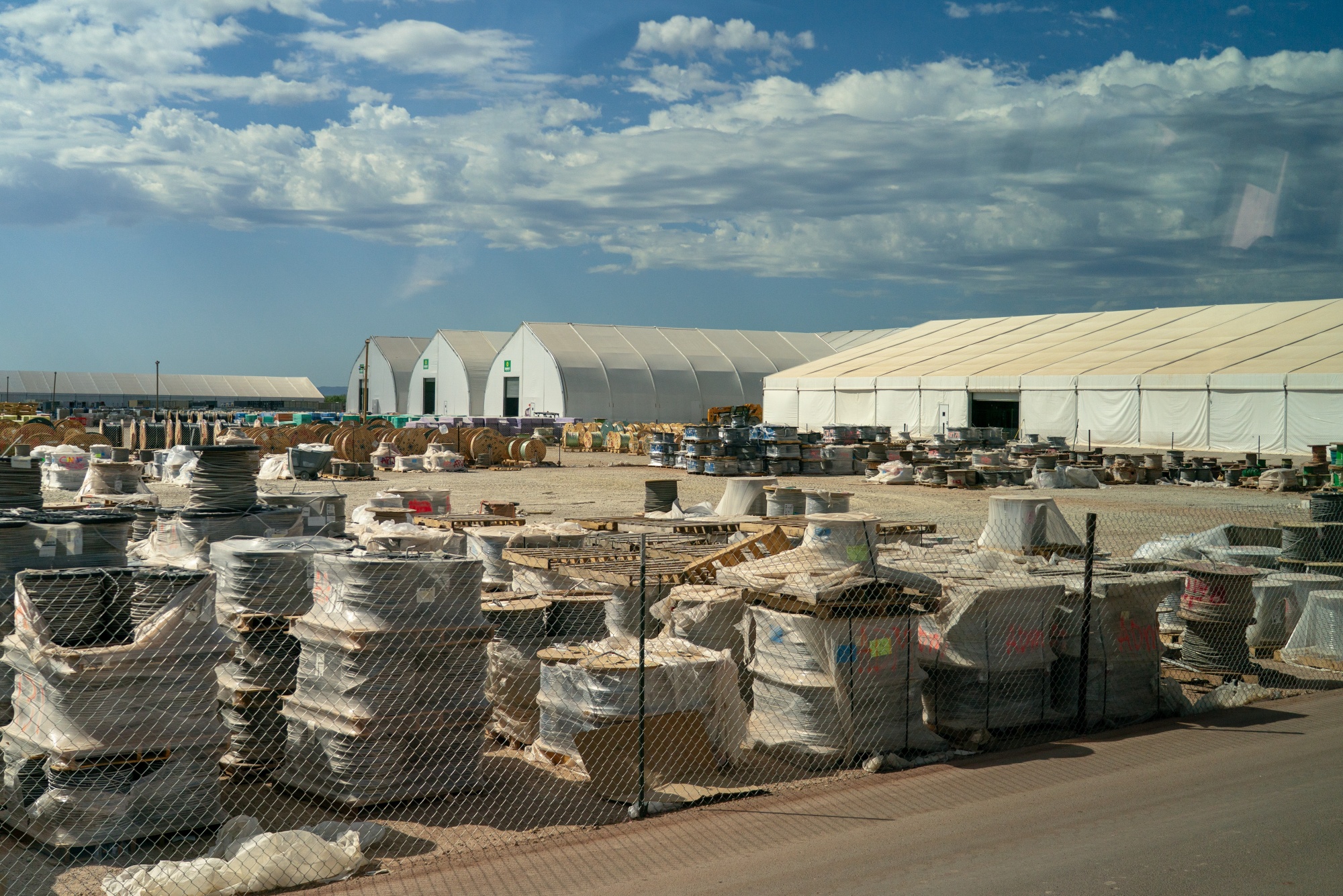 Spools of electrical wires outside a series of assembly tents at the Stargate AI data center in Abilene, Texas. Photographer: Kyle Grillot/Bloomberg