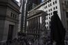 Pedestrians walk on Wall Street in front of the New York Stock Exchange (NYSE) in New York, U.S.