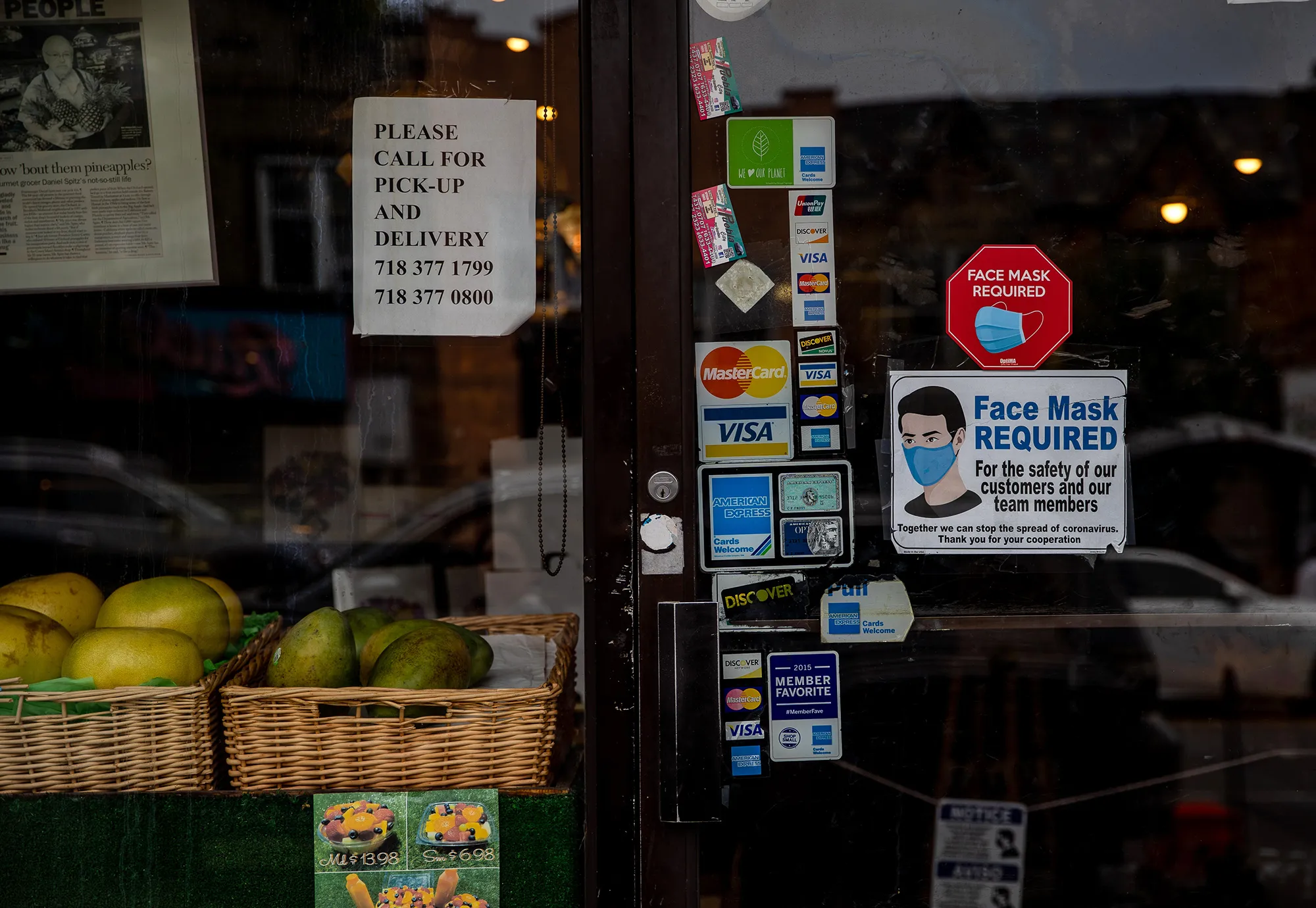 A "Mask Required" sign is displayed outside a deli&nbsp;in Brooklyn, New York.