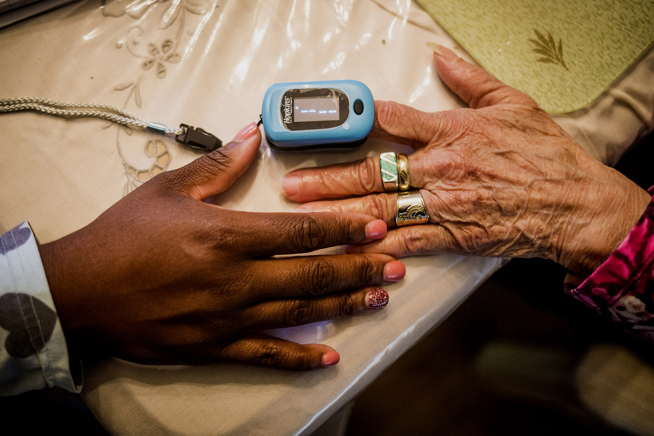 Margarita Varon has her heart rate taken by Clover Health Care nurse, Nakesha McPherson at her home in Plainfield, New Jersey, U.S., on Wednesday, October 26, 2016. John Taggart/Bloomberg