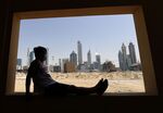 A man looks toward the Dubai skyline during lockdown, on April 5.