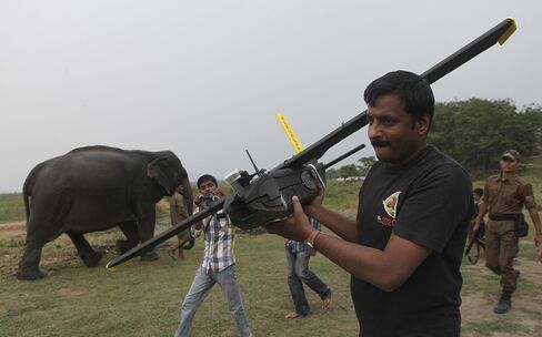 A World Wide Fund for Nature (WWF) official carries a drone at the Kaziranga National Park in Assam, India.