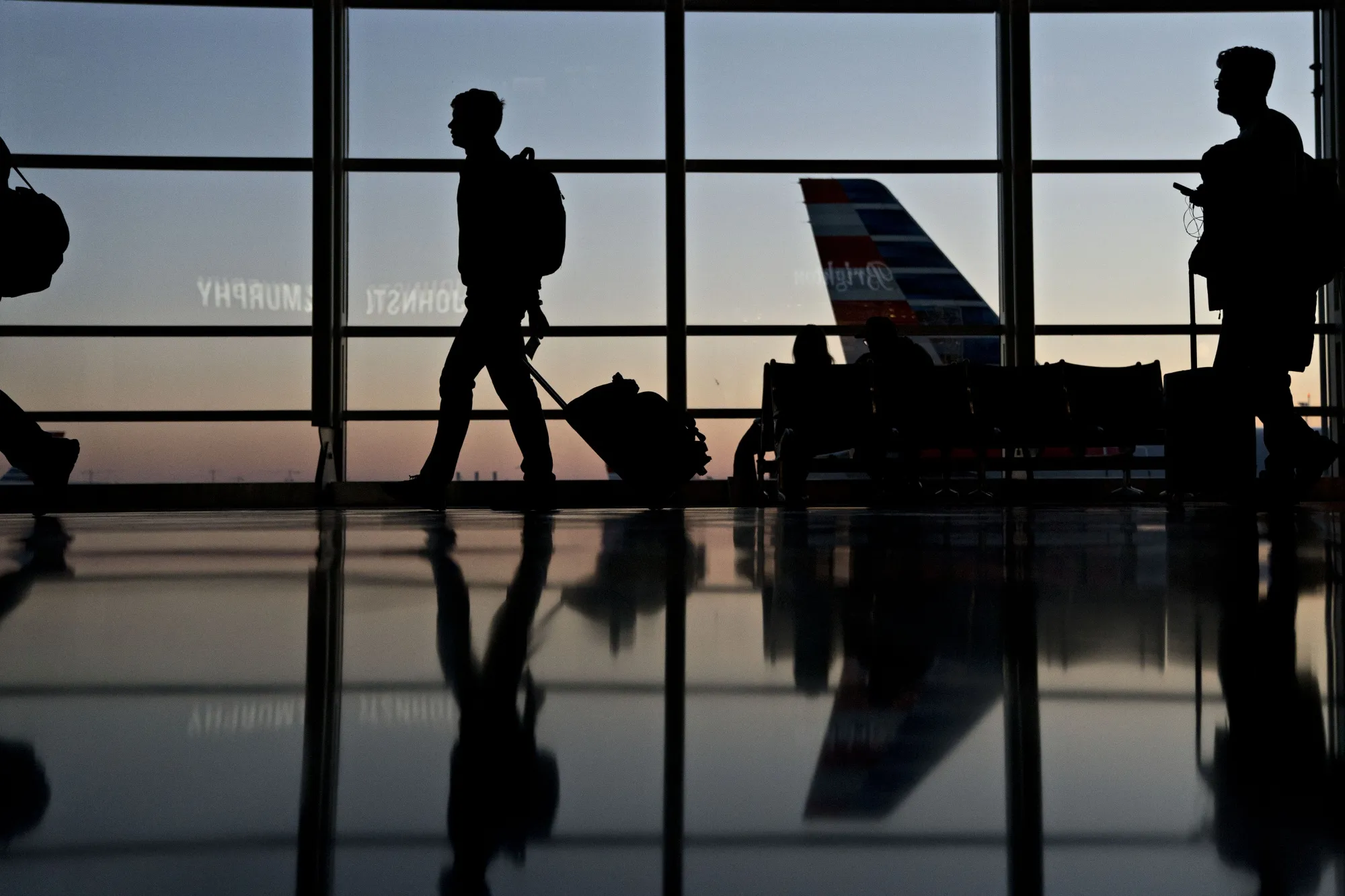 Travelers walk through Ronald Reagan National Airport in Washington.