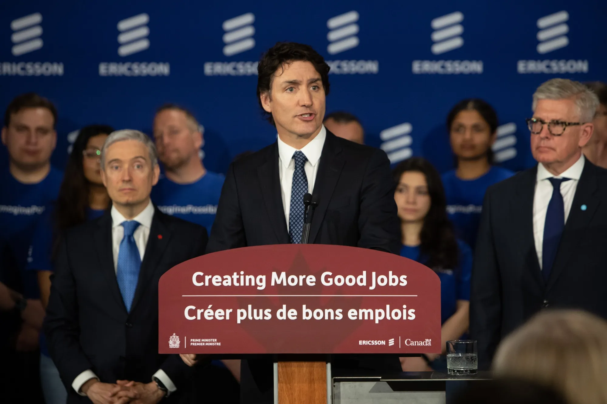 François-Philippe Champagne, left, looks on as Justin Trudeau speaks during a news conference in Ottawa on April 17.