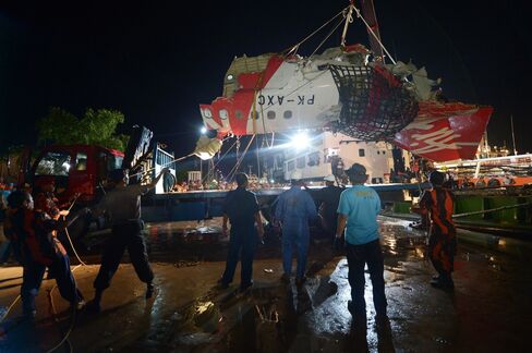 The tail section of the Air Asia aircraft is loaded onto a truck