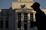 A runner passes the Marriner S. Eccles Federal Reserve building in Washington, D.C., U.S.