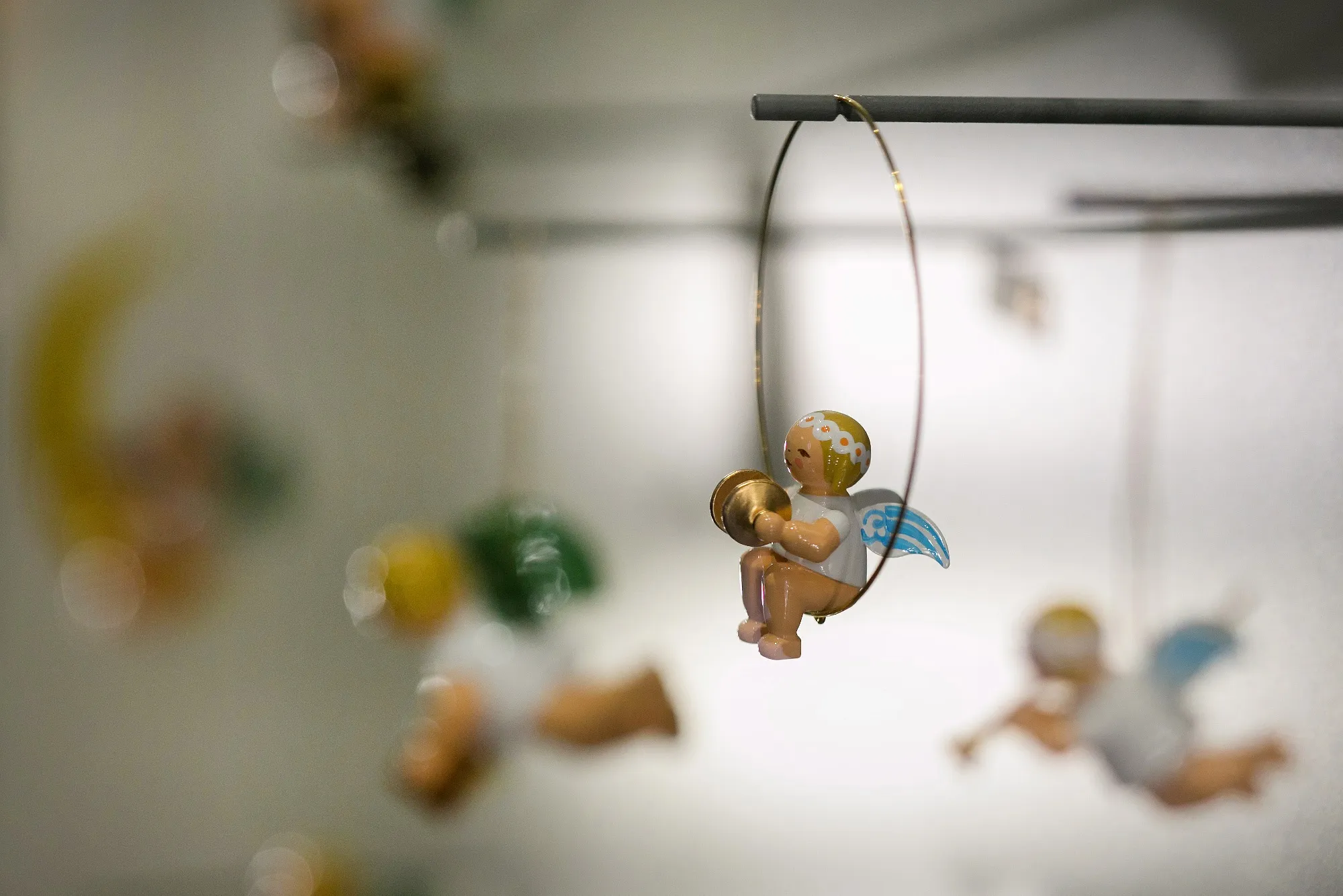 Angel figurines hang on display in the gift shop at the Wendt &amp; Kuehn KG traditional wooden festive decoration factory in Gruenhainichen, Germany.

