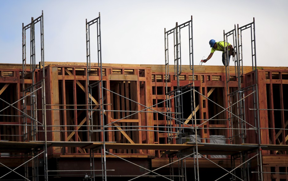 A construction worker builds framing at a housing construction project in San Francisco.