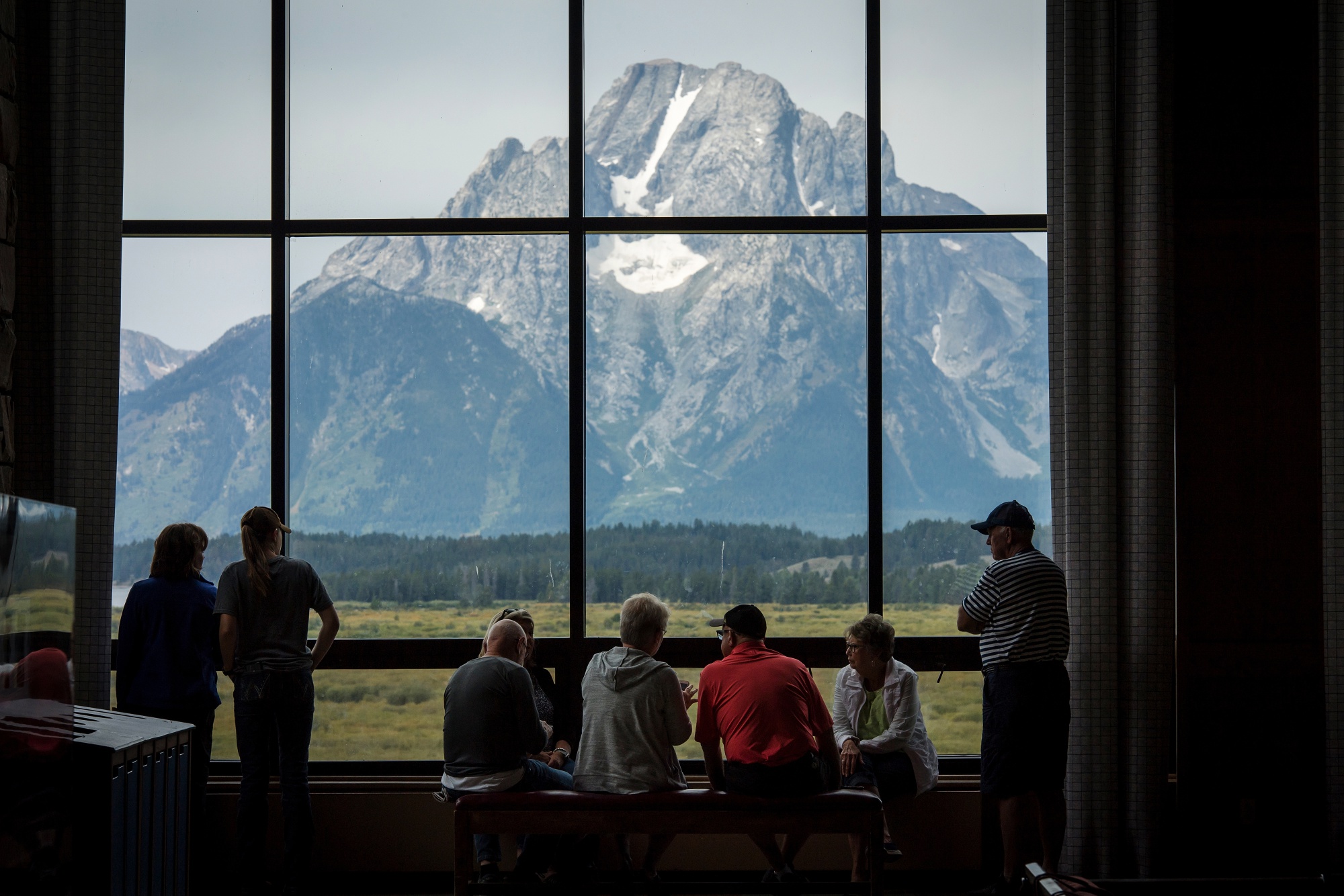 Visitors view the Grand Teton National Park mountain range from the Jackson Lake Lodge in Moran, Wyoming, U.S.