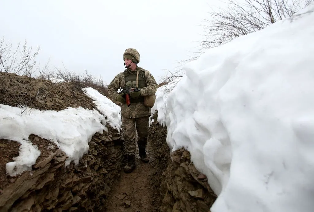 A Ukrainian Military Forces serviceman walks on a trench on the frontline with Russia-backed separatists near Luganske village, in the Donetsk region.