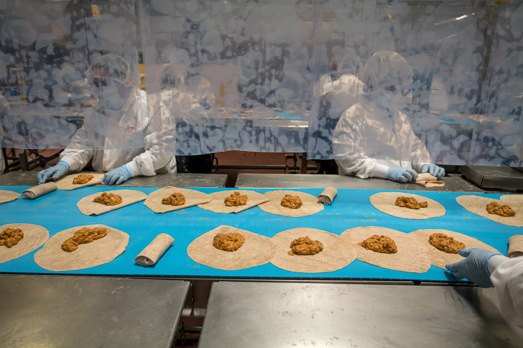 Workers wrap burritos at the Amy’s Kitchen facility in Santa Rosa, Calif.