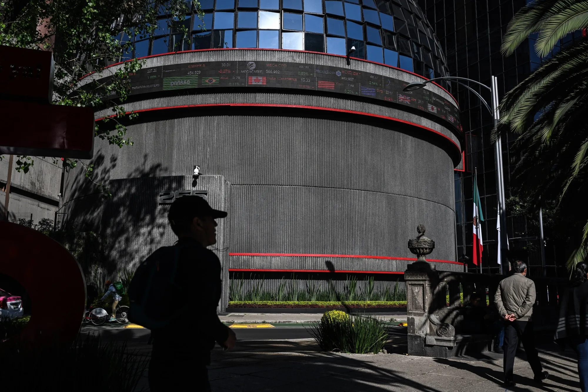 Pedestrians pass in front of the Bolsa Mexicana de Valores, Mexico's stock exchange, in Mexico City, Mexico.