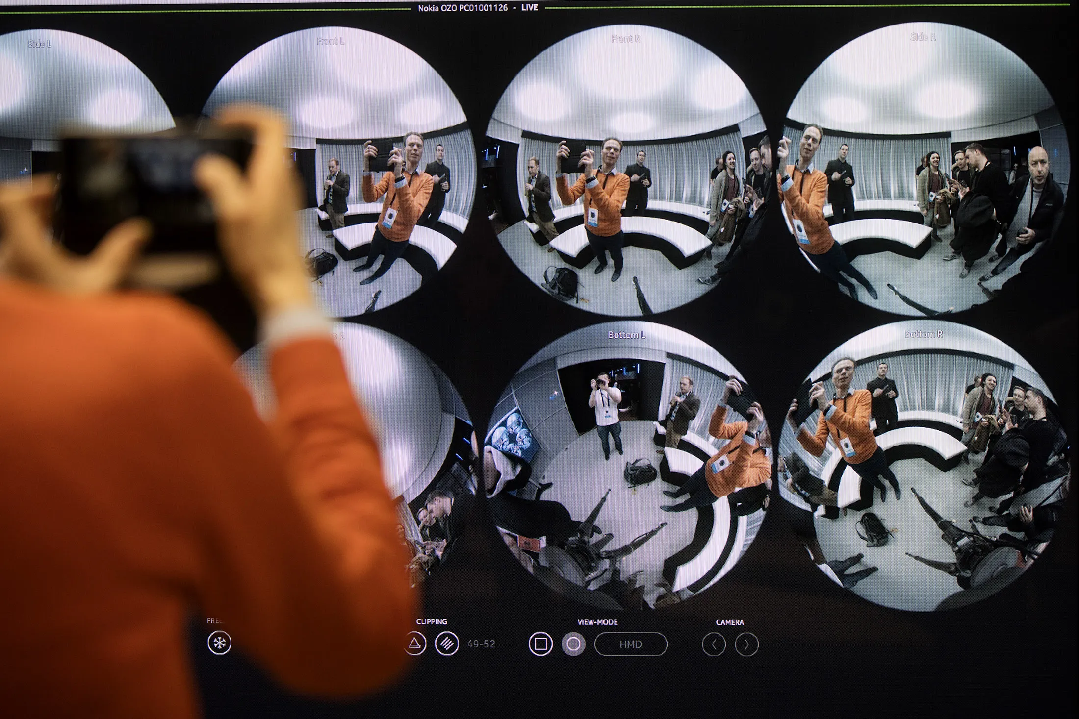 An attendee takes a photo of the live feed of the Ozo, a virtual reality camera, manufactured by Nokia Oyj, at the European launch in London, U.K., on Thursday, March 17, 2016. The ball-shaped gadget has eight shutter sensors capturing 3D footage for the creation of content for devices such as virtual-reality headsets, Nokia said in a statement.
