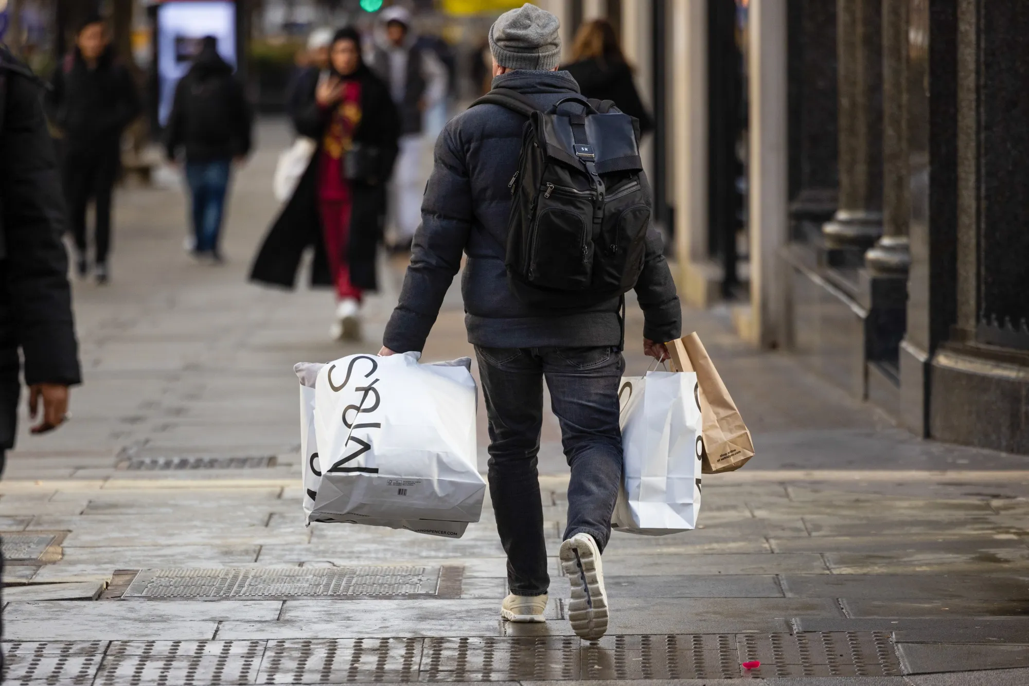 A shopper with Marks & Spencer bags in London.