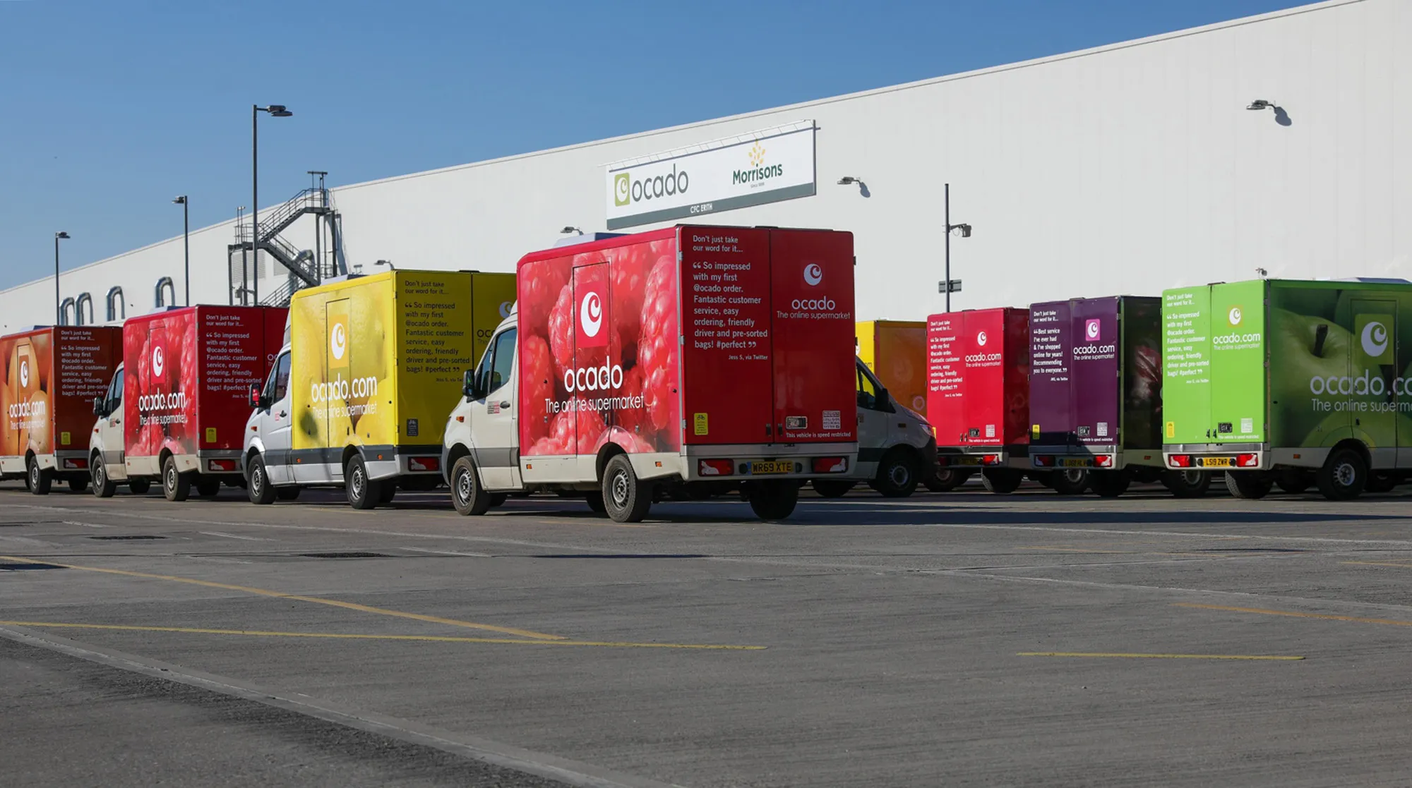 Delivery vans sit parked at an Ocado Group&nbsp;customer fulfillment center&nbsp;in Erith, U.K., on&nbsp;March 25.