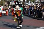 Mickey Mouse waves to fans during a parade at Walt Disney World Resort.