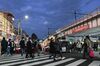Pedestrians use a street crossing close to the Ameya Yokocho market in the Ueno district of Tokyo, Japan, on Wednesday, Dec. 30, 2020. Tokyo could see an explosive increase in virus cases at any time, and everybody is at risk of infection, Governor Yuriko Koike said Wednesday, warning residents to take precautions as Japan heads into the New Year holidays.