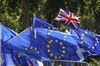 A Union flag, also known as a Union Jack, flies above European Union (EU) flags during an anti-Brexit protest near the Houses of Parliament in London, U.K., on Wednesday, July 24, 2019. British business is wasting no time in urging new U.K. Prime Minister Boris Johnson to avoid crashing out of the European Union.