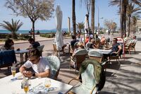 Tourists at the terrace of a restaurant in Palma Beach in Palma de Mallorca on March 29.