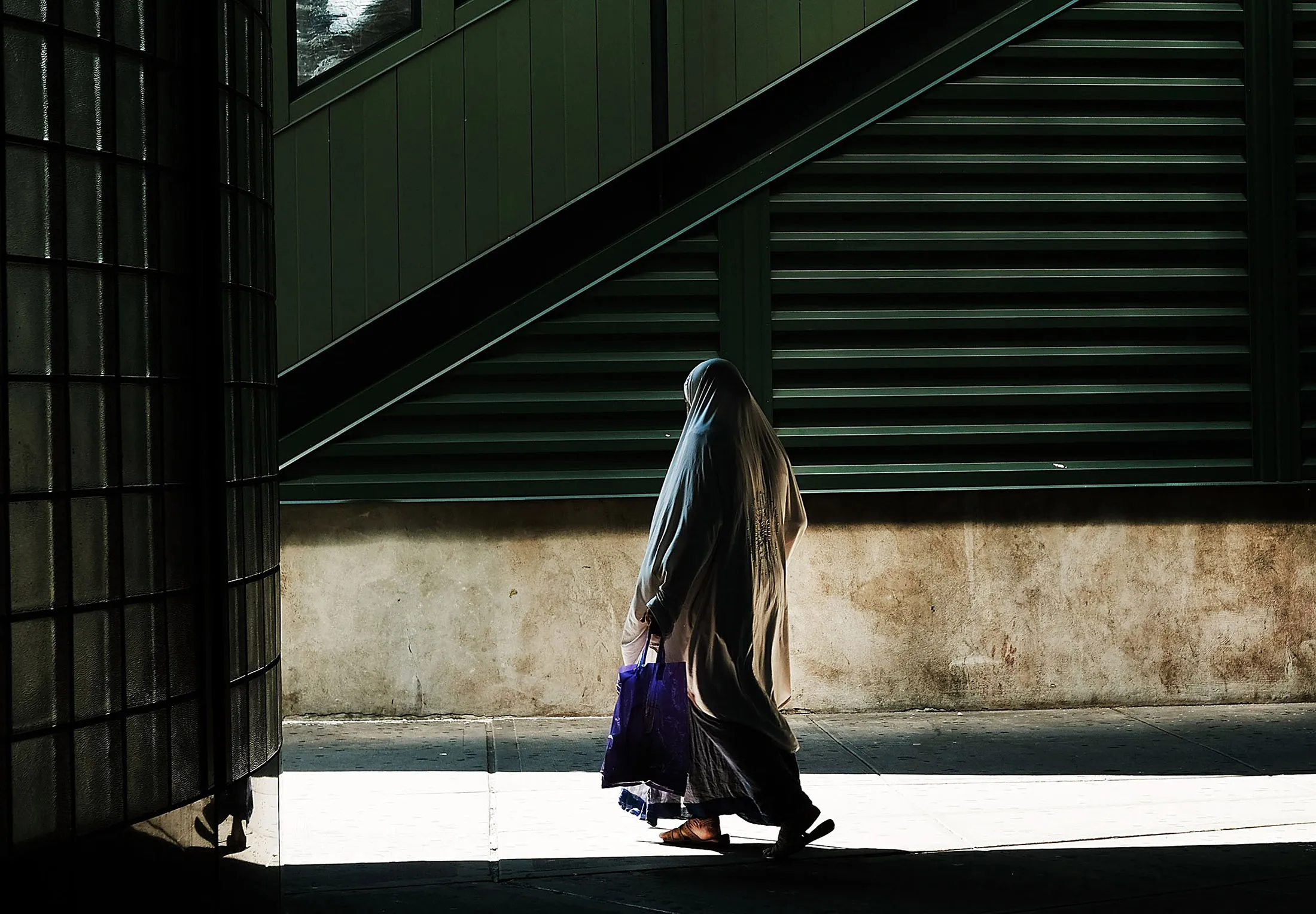 NEW YORK, NY - AUGUST 29: A Muslim woman walks in an ethnically a diverse neighborhood in Queens on August 29, 2016 in New York City. Queens County is one of the five most diverse counties in the United States with a large Latino and Asian population among other groups. Immigration has once again become a topic dividing the candidates in the upcoming U.S. presidential election. Republican presidential candidate Donald Trump, who has been an advocate of building a wall with Mexico and deporting all illegal immigrants, is expected to give a speech on Wednesday to clarify his positions on immigration policy.
