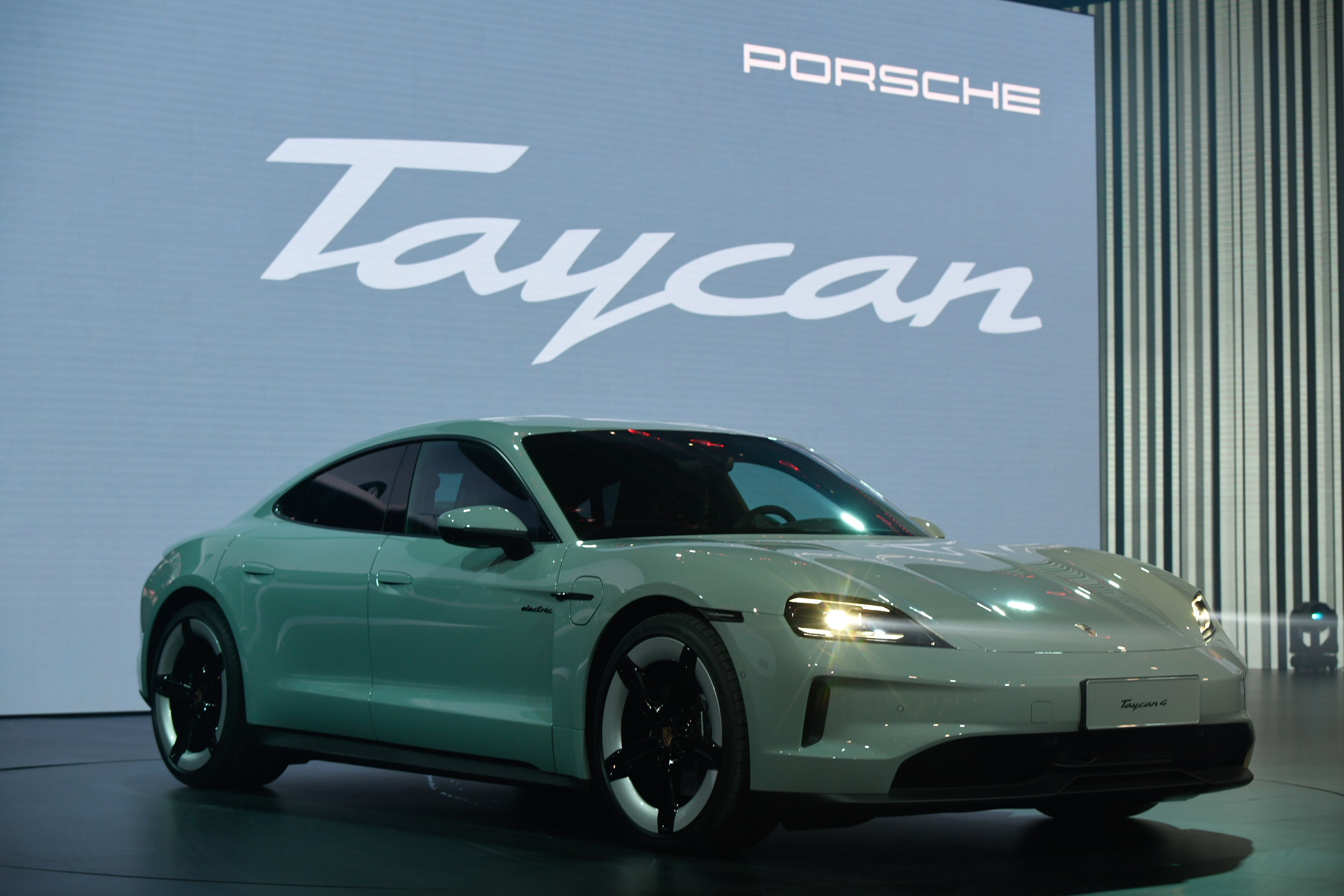 The new Porsche Taycan model at the Volkswagen AG launch event in Beijing, China, on Wednesday, April 24, 2024. Volkswagen AG will start sales of a new electric-vehicle brand in China kitted out with gadgets like an in-car avatar to help win back young buyers it has lost to the likes of BYD Co. Source: Bloomberg