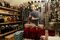 Tom Adams selects a wine in his cellar, where he also pickles vegetables.