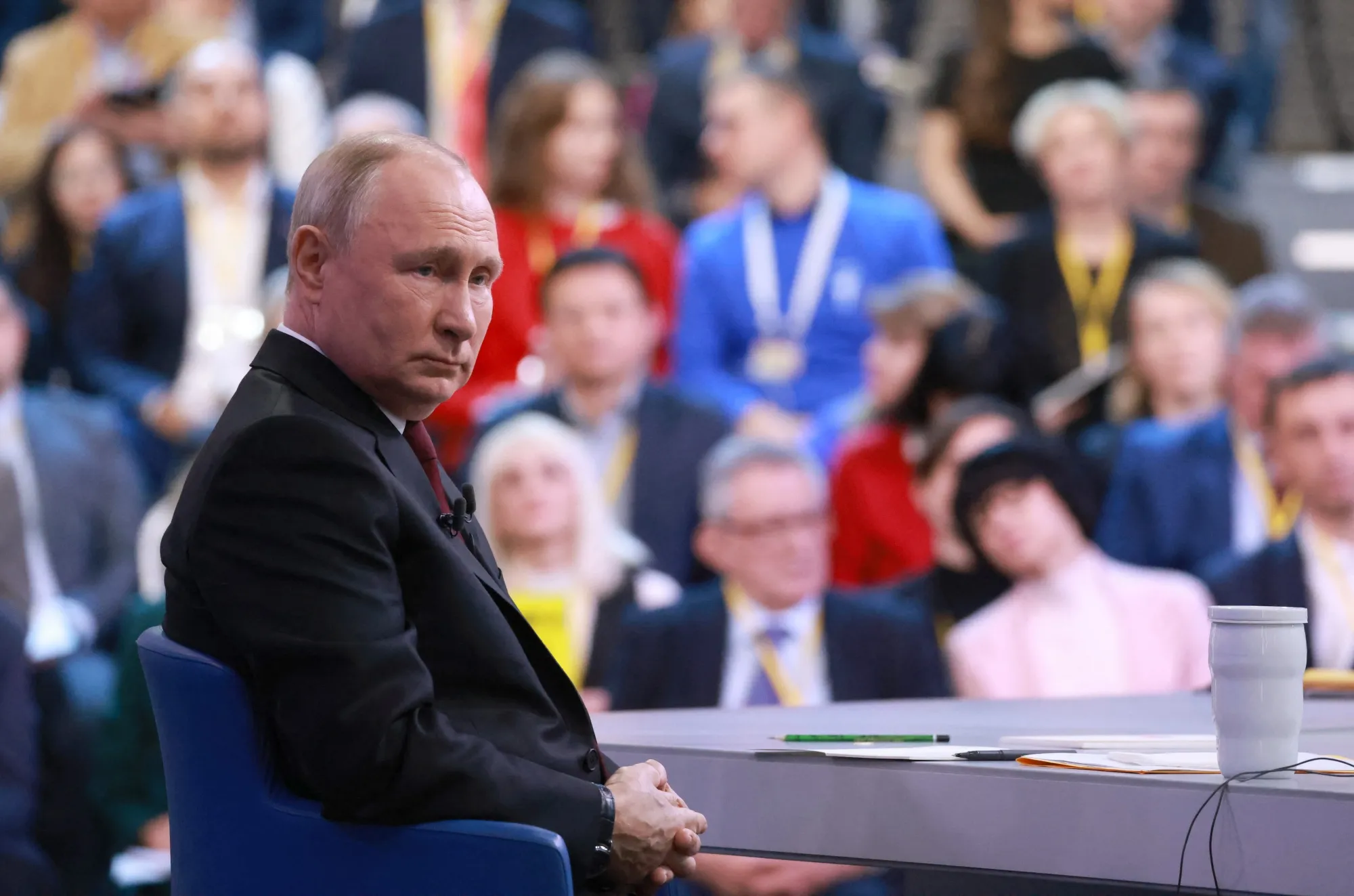 In a photo distributed by Russia's state agency Sputnik, Vladimir Putin delivers his year-end press conference.