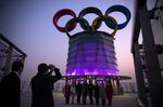Visitors pose for photographs at the observation deck at the Olympic Tower in Beijing on&nbsp;Jan. 7.