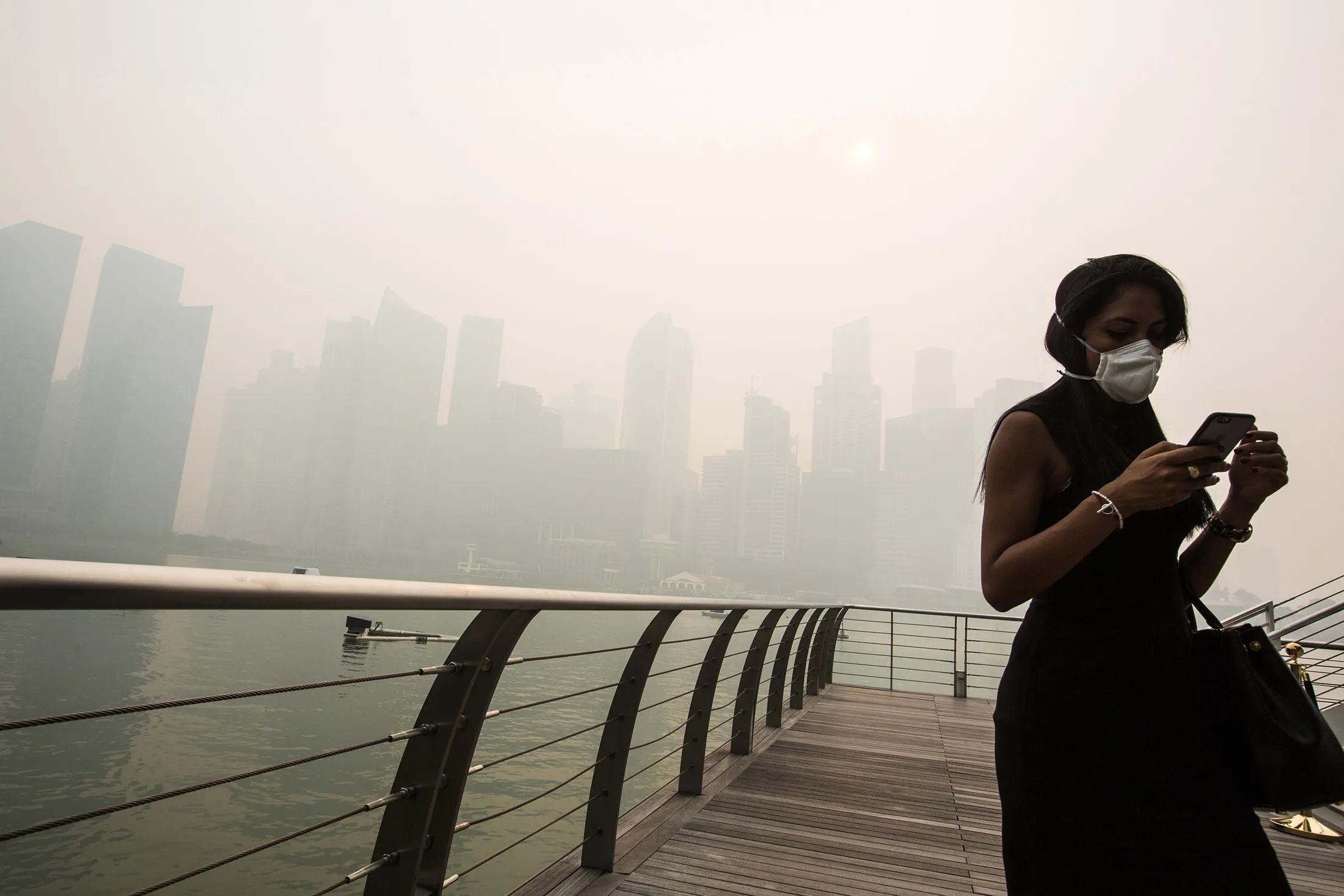A pedestrian wears a face mask in Singapore.

